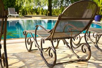 lounge chair next to swimming pool