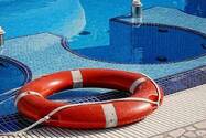 Pool flotation device next to swimming pool